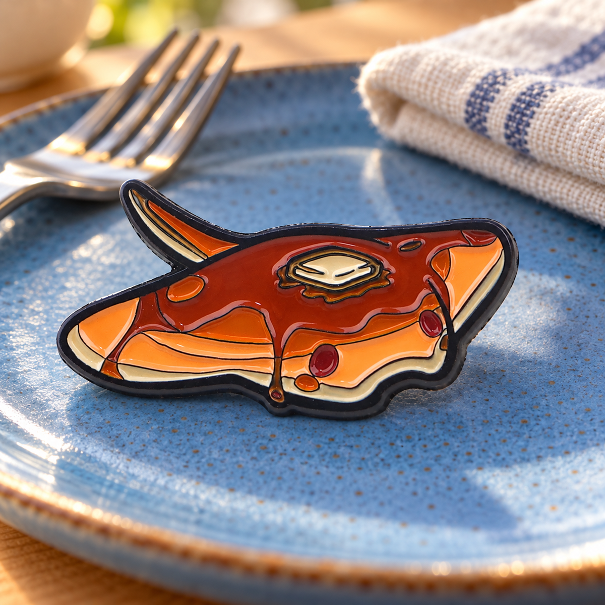 Manta Ray Pancake Pin enamel pin in a lifestyle setting