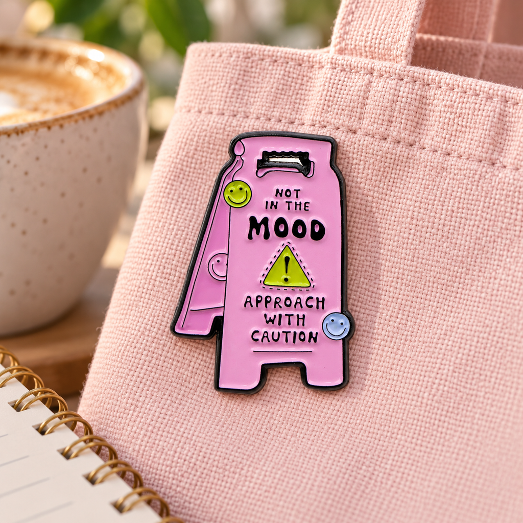Warning Sign Pin enamel pin in a styled lifestyle setting