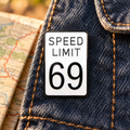 Speed Limit 69 Sign Pin enamel pin in a styled lifestyle setting