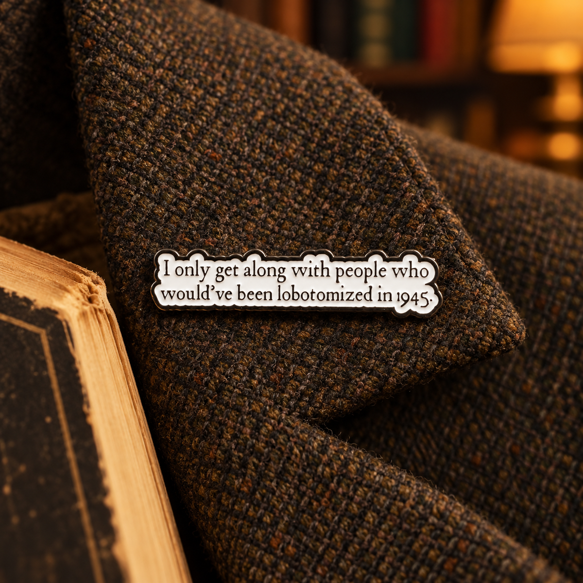 1945 lobotomized quote enamel pin on vintage tweed by an old book
