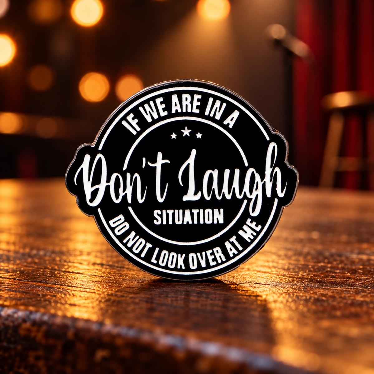 Don't Laugh enamel pin in a comedy club