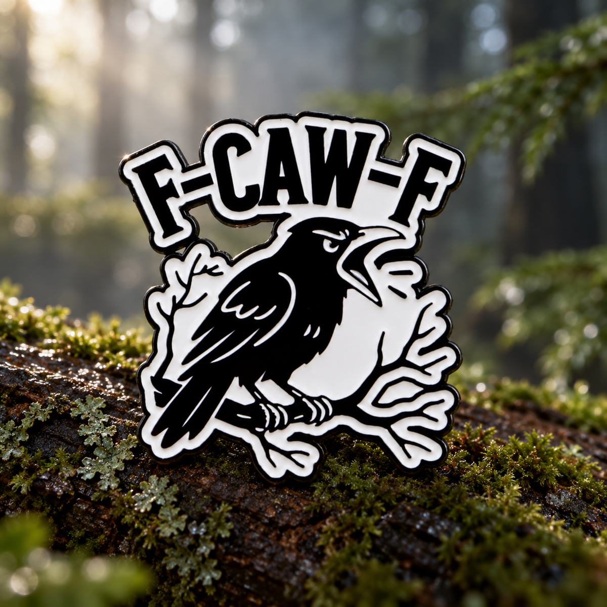 F-CAW-F crow enamel pin in a woodland setting