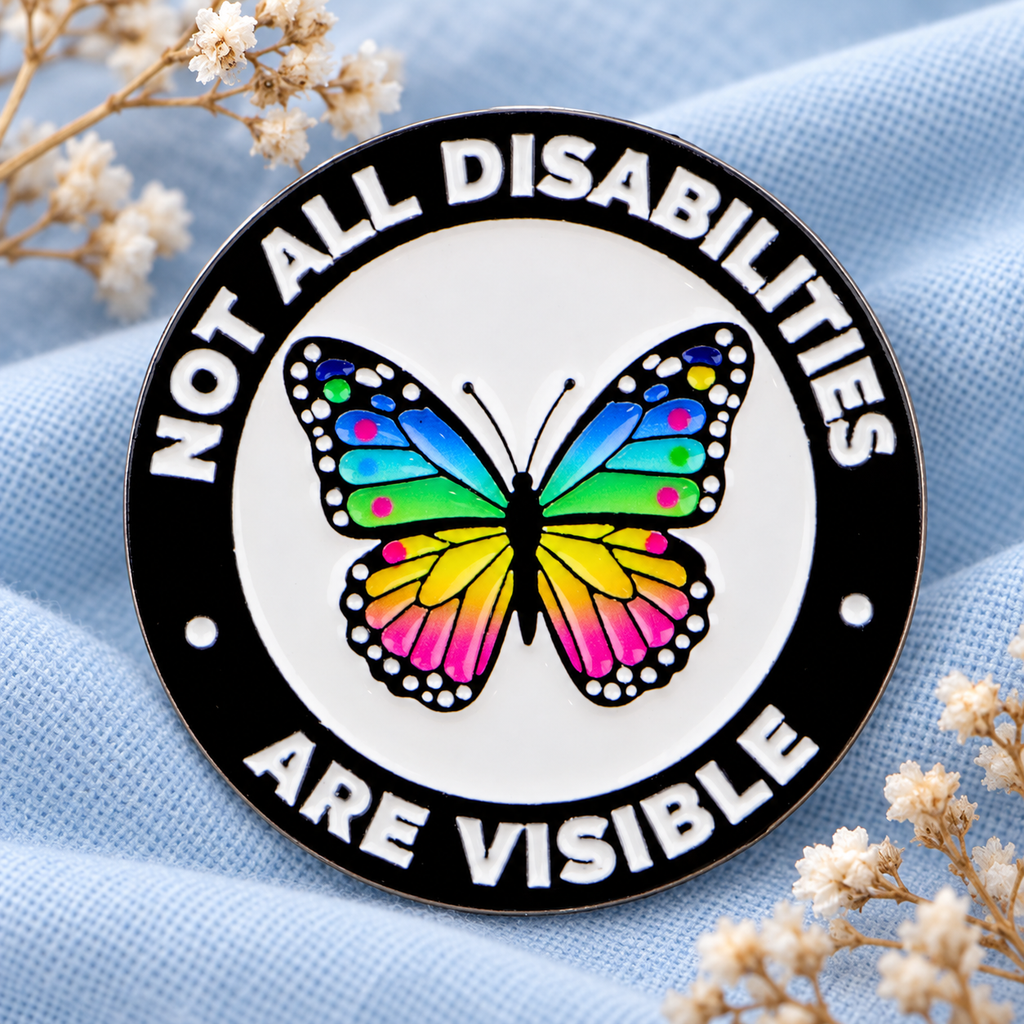 Not All Disabilities Are Visible Butterfly Pin displayed in a styled lifestyle setting