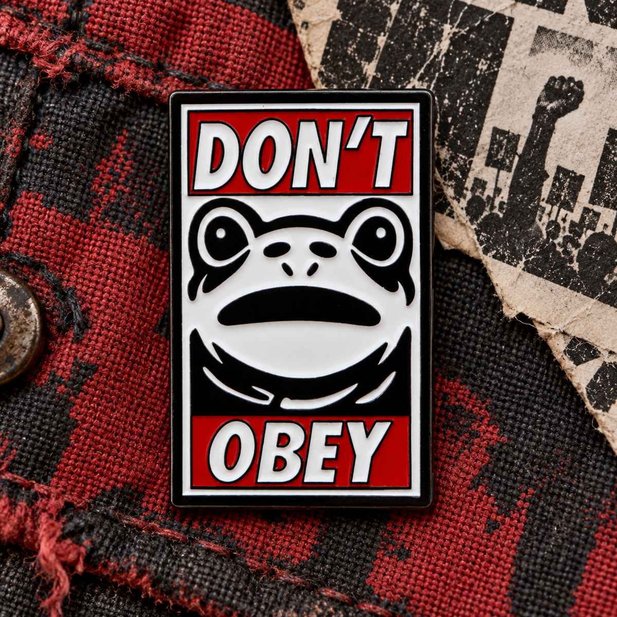 Don't Obey Frog Pin displayed in a styled lifestyle setting