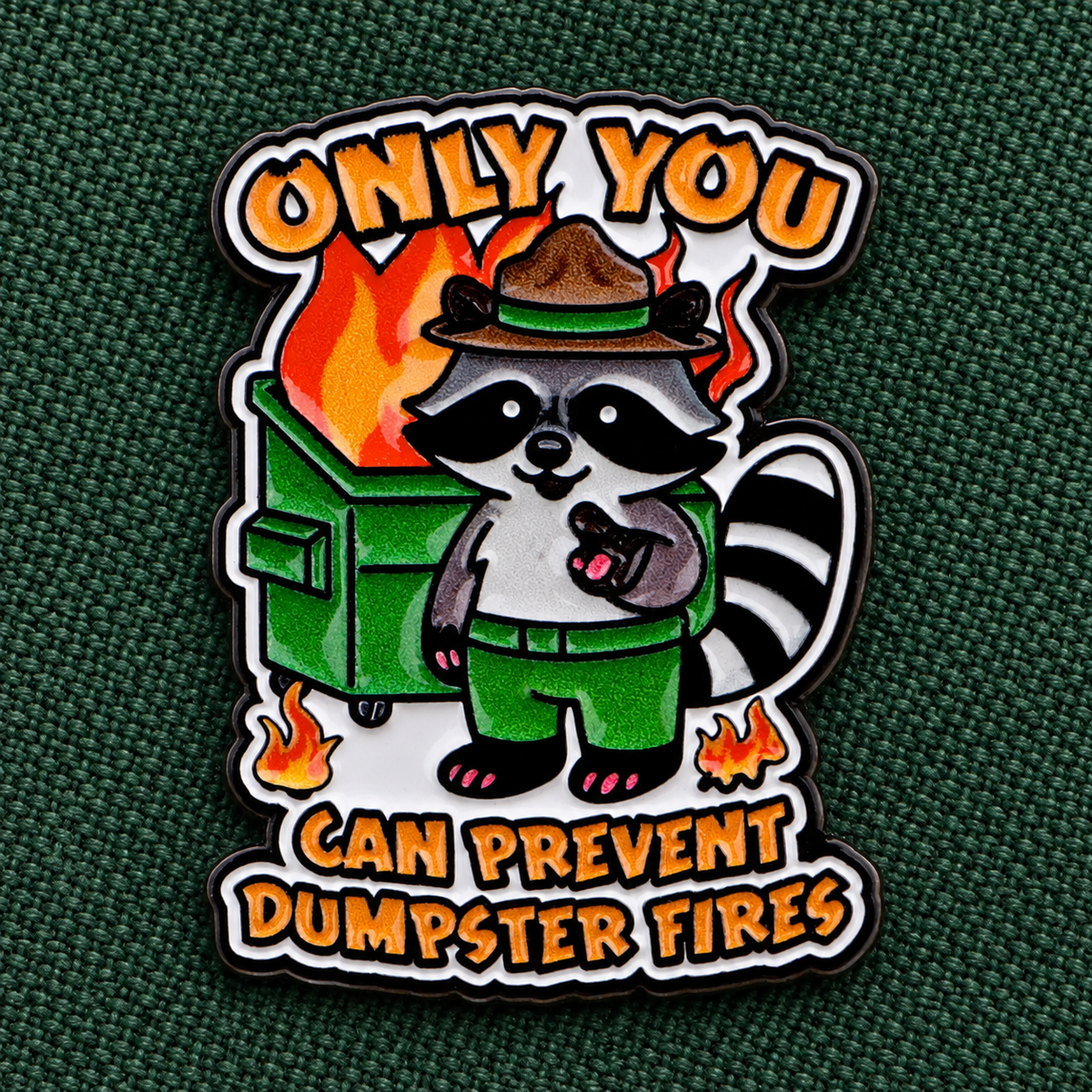 Only You Can Prevent Dumpster Fires Raccoon Pin displayed in a styled lifestyle setting
