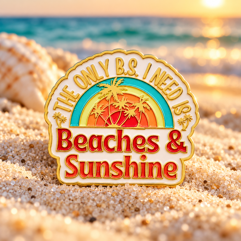 Beaches and Sunshine enamel pin on golden-hour beach sand
