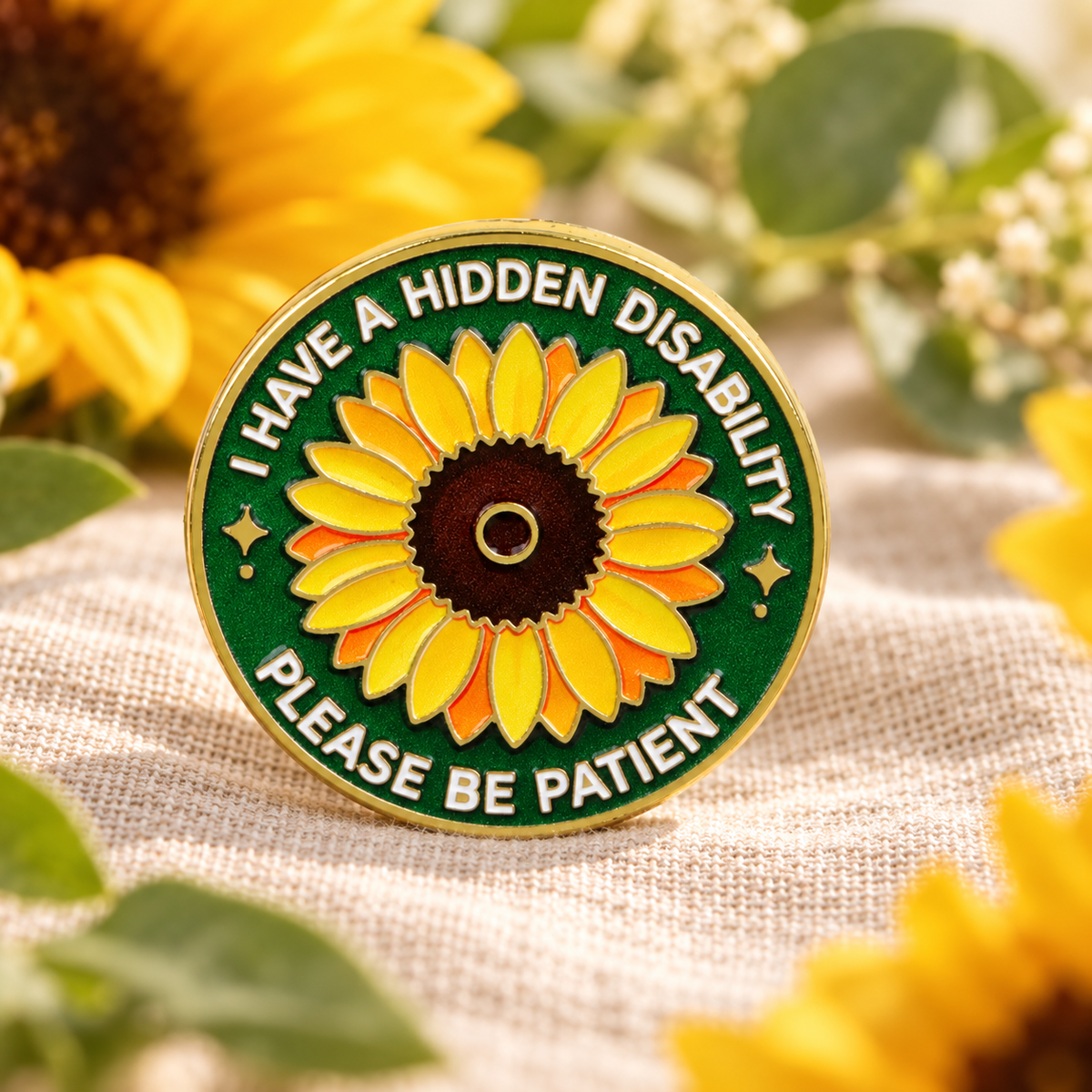 Hidden disability sunflower enamel pin on a soft botanical backdrop