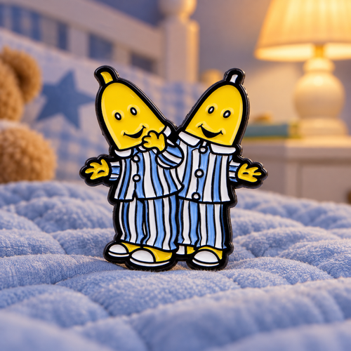 Bananas in Pyjamas enamel pin on a cozy blue quilt