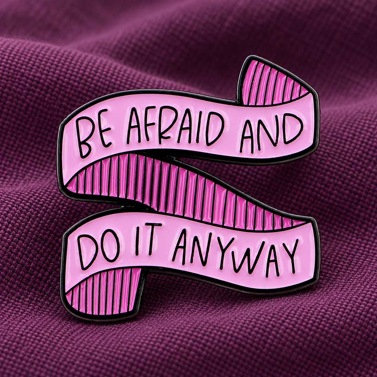 Be Afraid and Do It Anyway enamel pin on plum canvas
