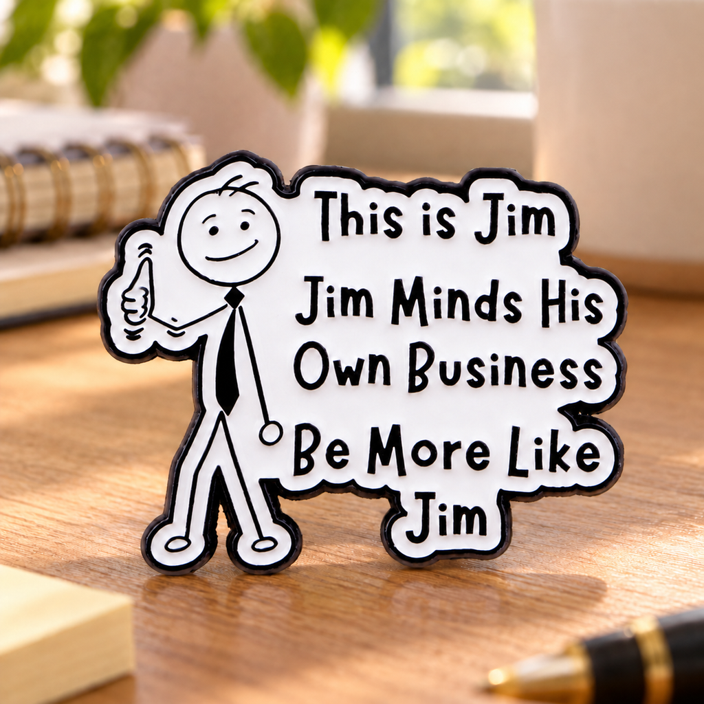 Be More Like Jim enamel pin on a warm home-office desk