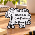Be More Like Jim enamel pin on a warm home-office desk