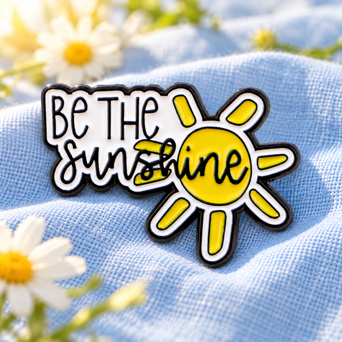 Be The Sunshine enamel pin on sky-blue linen