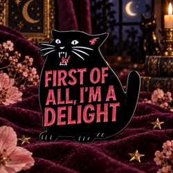 Black cat enamel pin on plum velvet at night