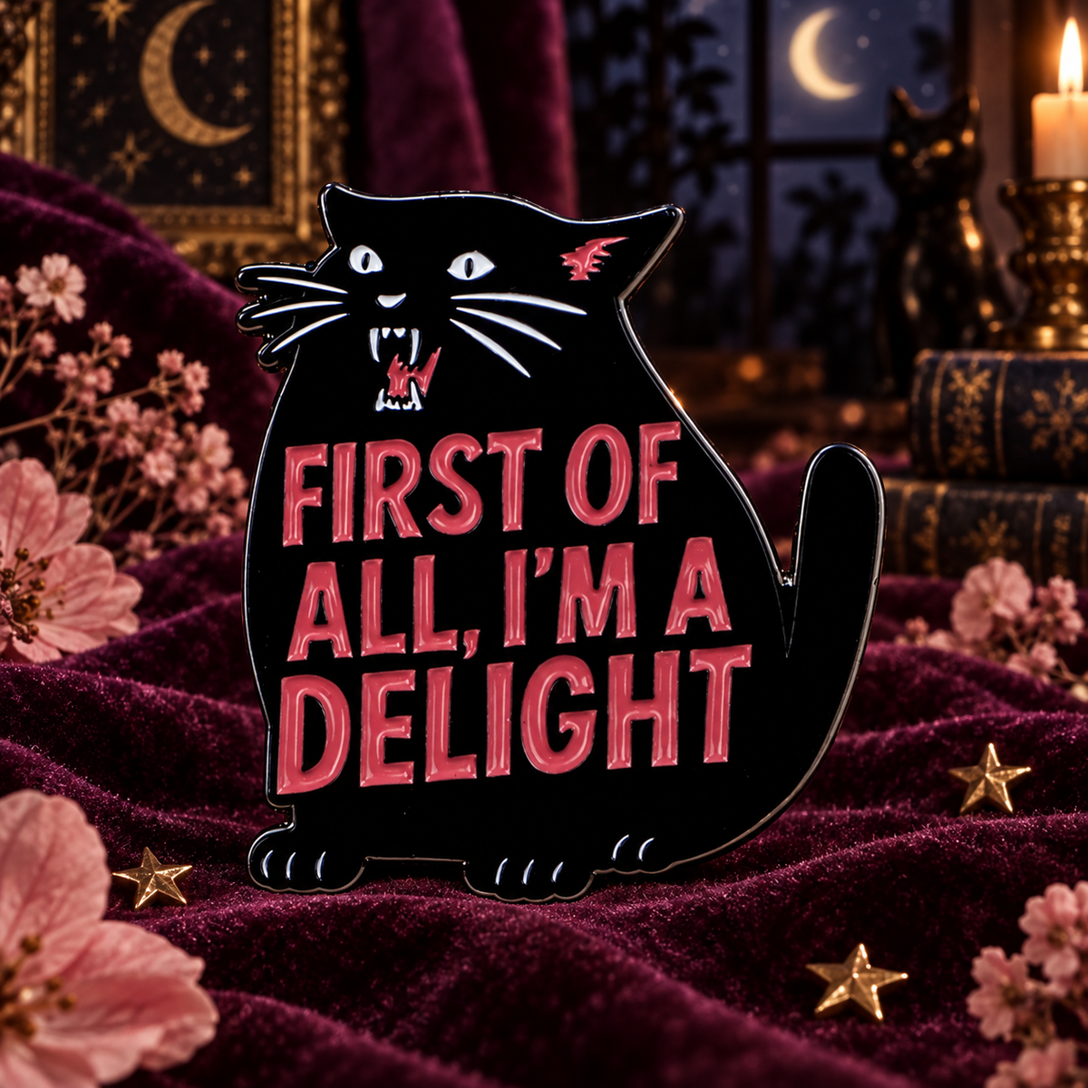 Black cat enamel pin on plum velvet at night
