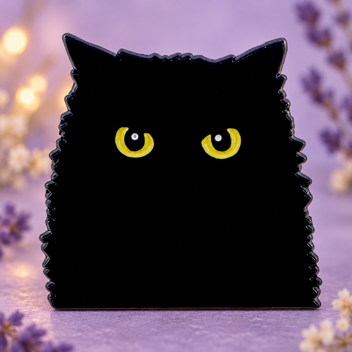 Black Cat enamel pin on a softly lit lavender tabletop