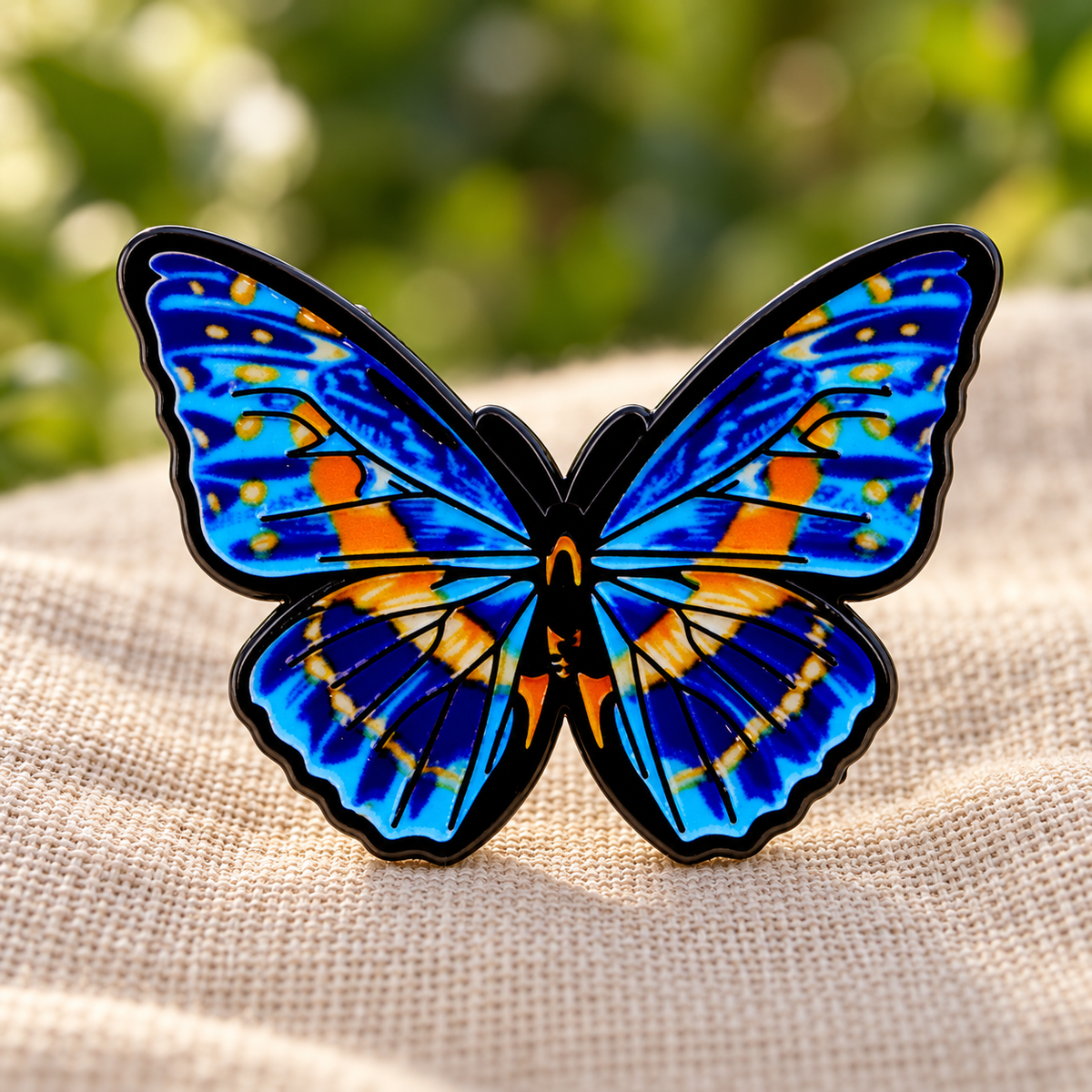 Blue butterfly enamel pin on cream linen