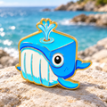 Blue Cube Whale Pin on a coastal background