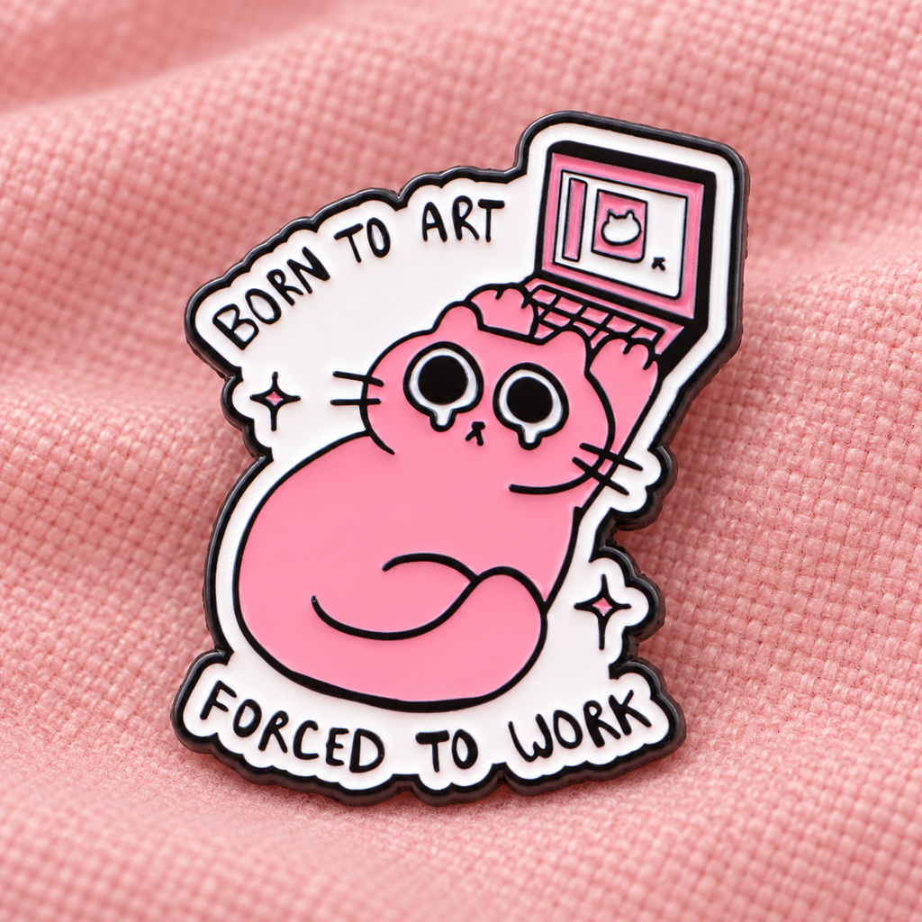 Born to Art Forced to Work cat enamel pin on pink fabric