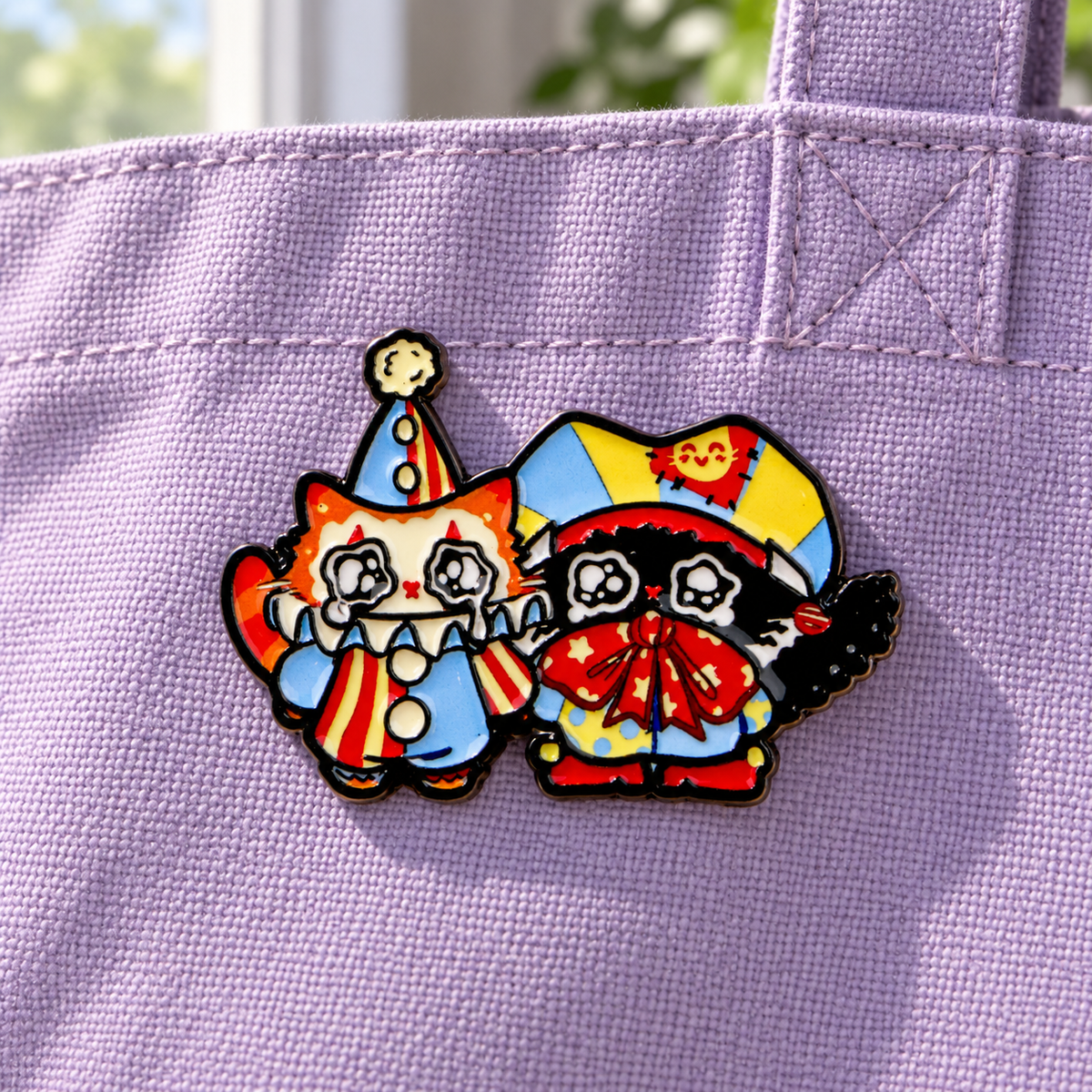 Crying Kittens in Clown Costumes enamel pin on lavender canvas
