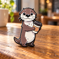 Coffee otter enamel pin on a warm café table