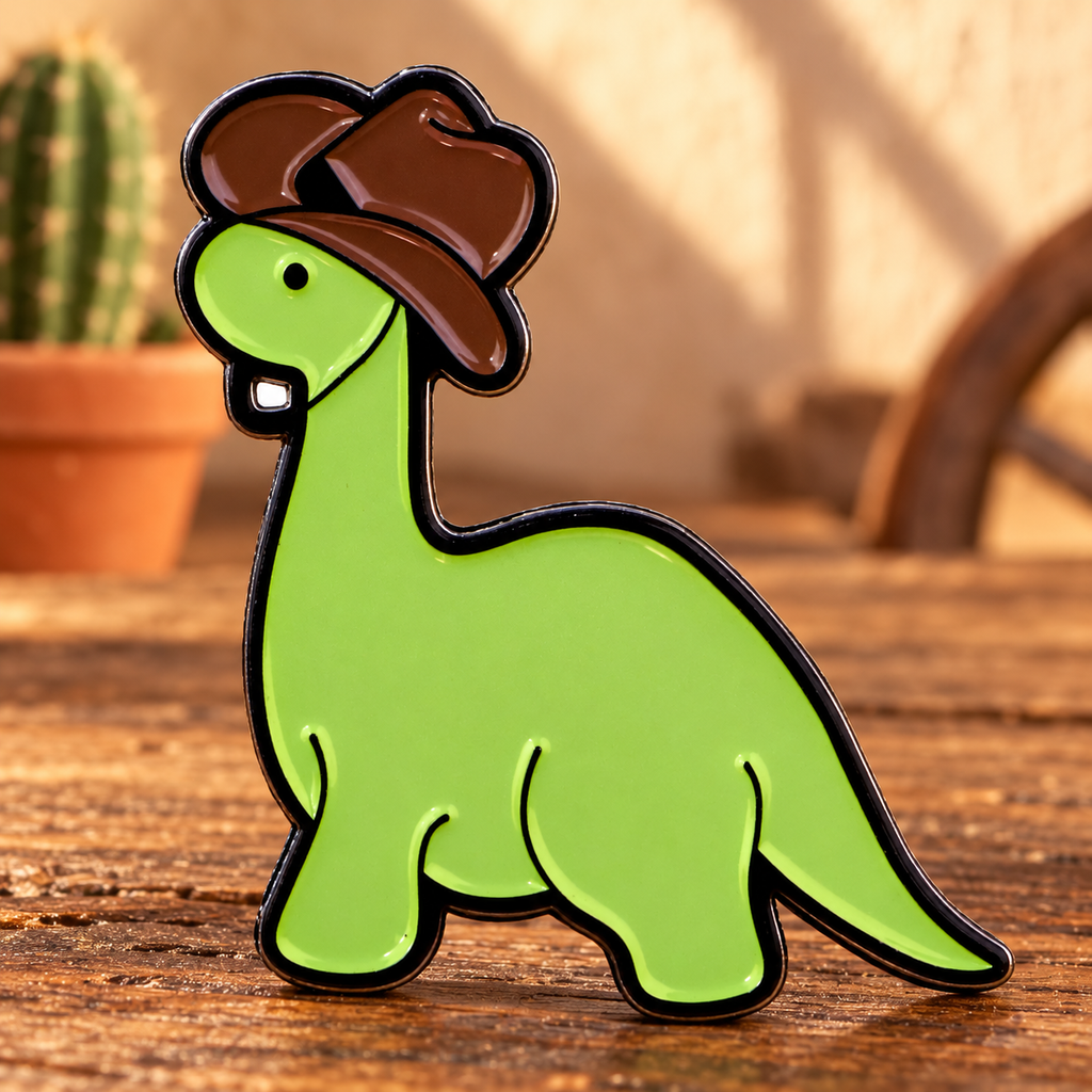 Cute Cowboy Dinosaur Pin enamel pin on a Western desk