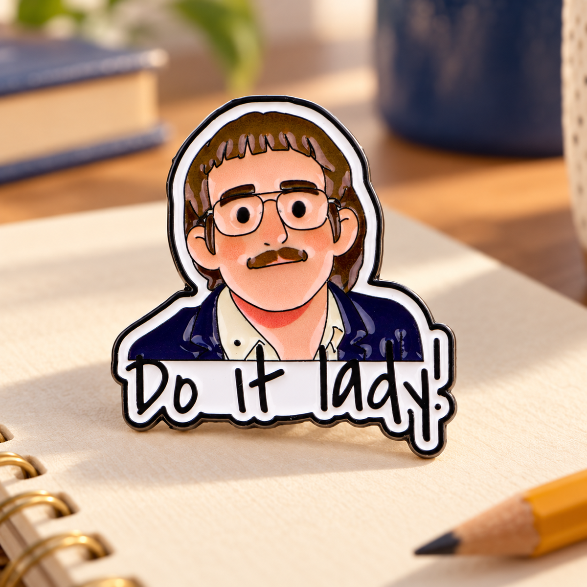 Do It Lady Cartoon Portrait Pin on a sunny creative desk