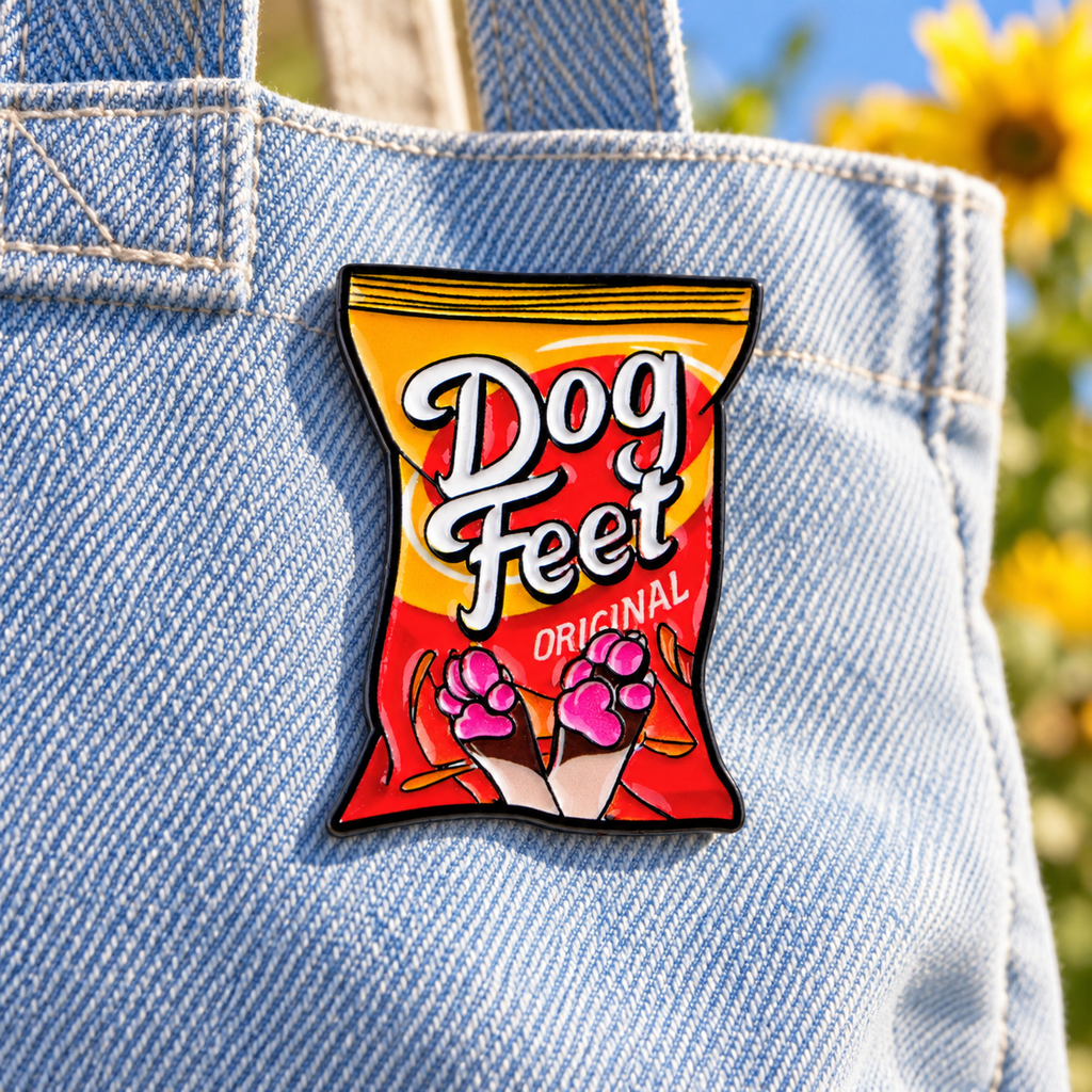 Dog Feet Snack enamel pin on a light denim tote
