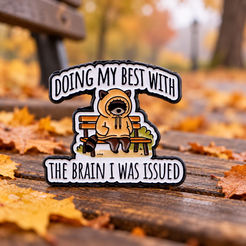 Doing My Best raccoon enamel pin in an autumn park