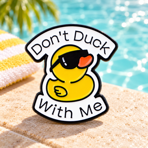 Don't Duck with Me sunglasses enamel pin beside a sunny pool