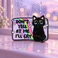 Don't Yell at Me I'll Cry black cat enamel pin against a pastel rainy window
