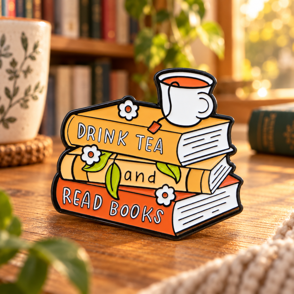Drink Tea and Read Books enamel pin in a cozy reading nook