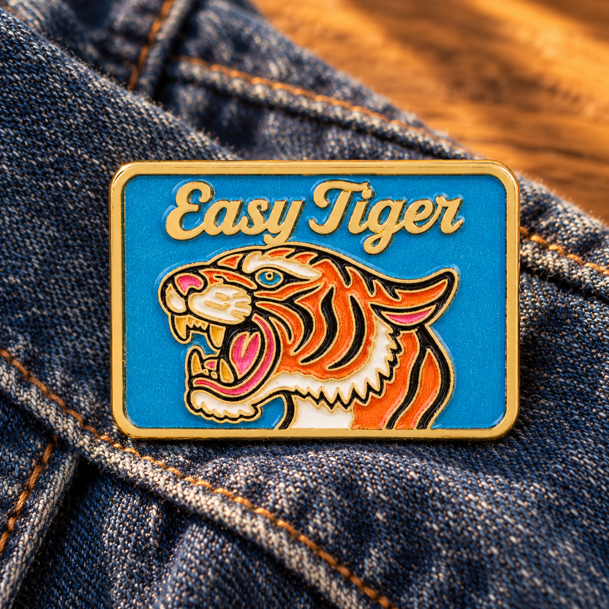 Easy Tiger enamel pin on indigo denim