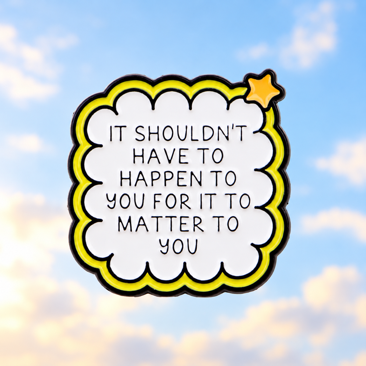 Empathy quote pin against a soft hopeful sky
