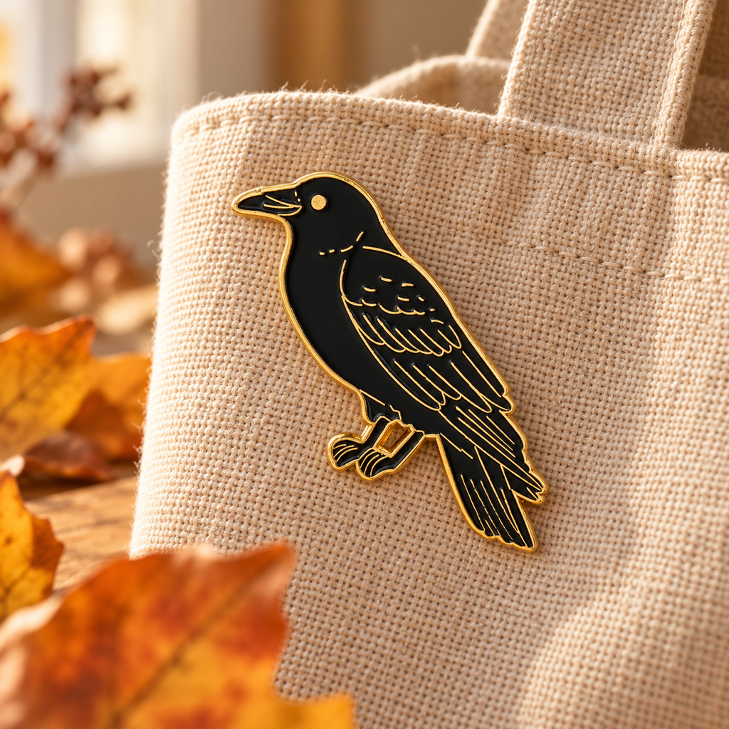 Black crow enamel pin on autumn linen tote