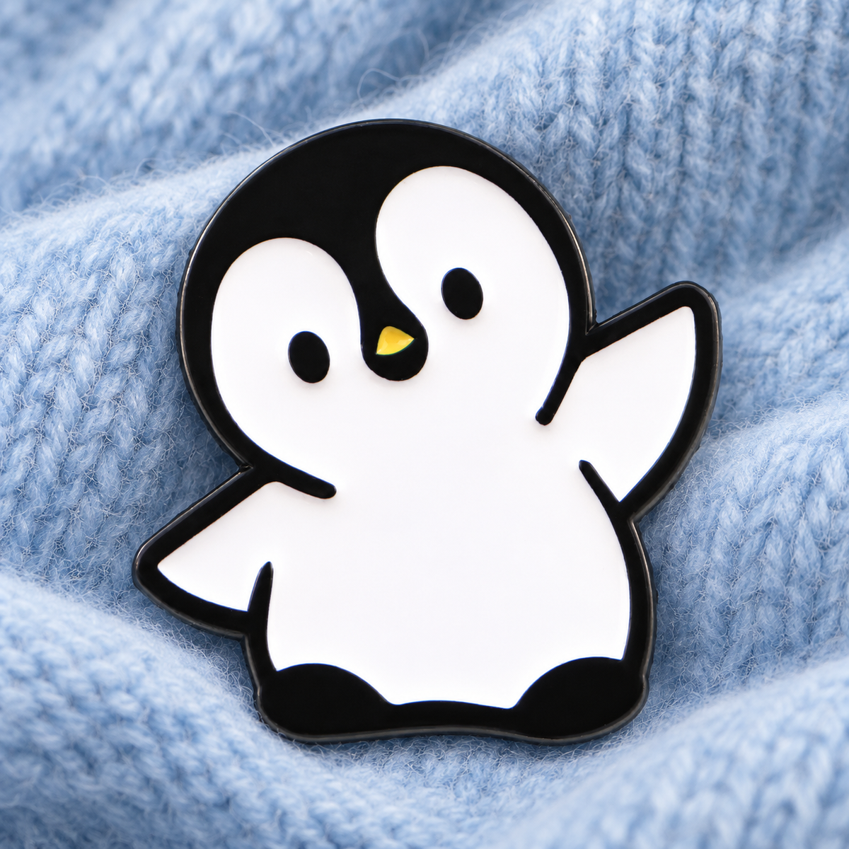 Cute Penguin enamel pin on pale blue wool