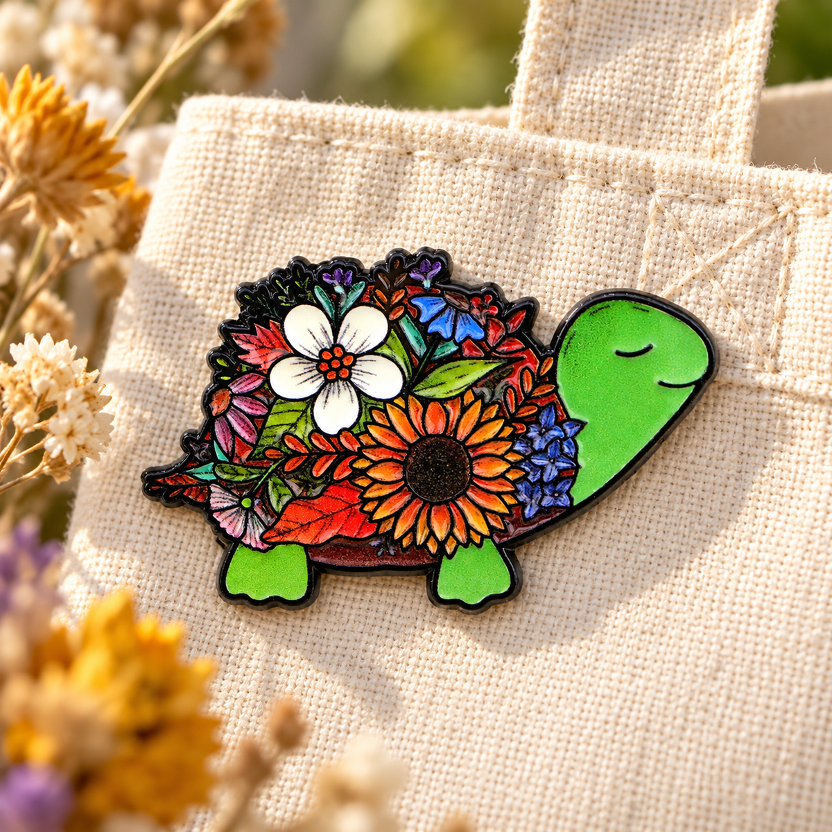 Cute Flower Turtle Pin enamel pin on a cream gardening tote