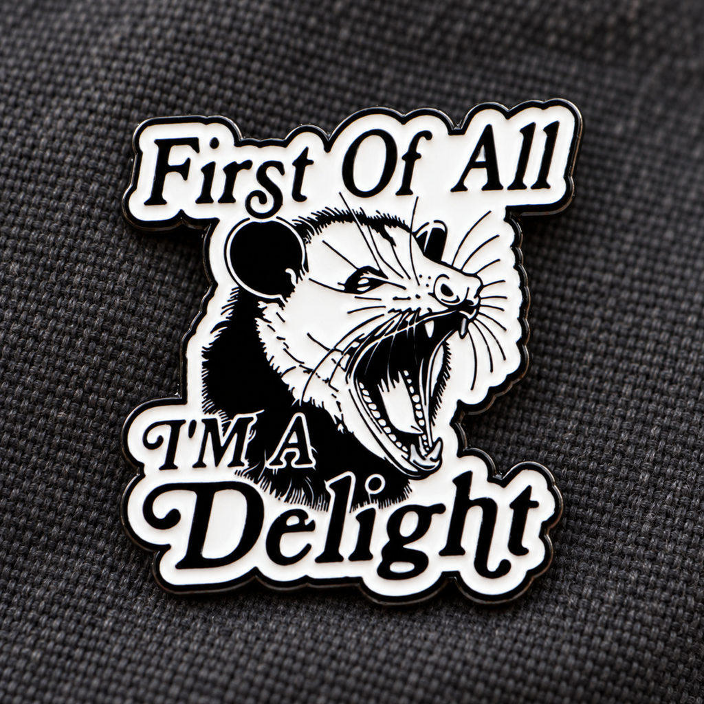 First of All I'm a Delight opossum enamel pin on charcoal fabric