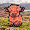 Fluffy Highland Calf enamel pin in a Highland meadow
