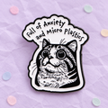 Full of Anxiety and Micro Plastics cat enamel pin on a lilac paper background