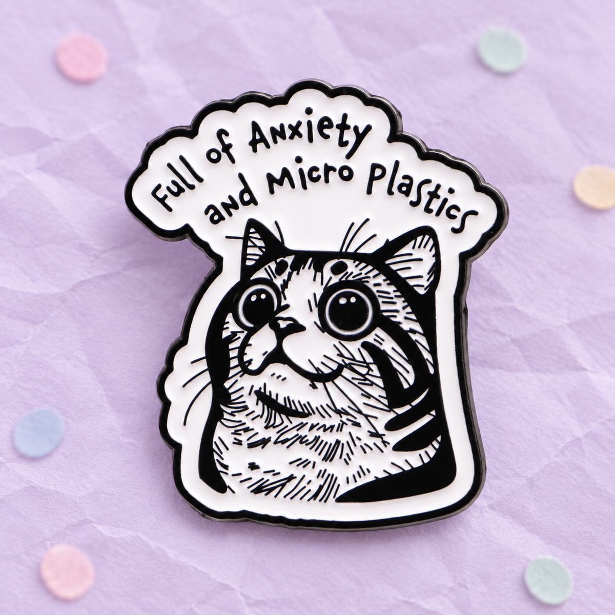 Full of Anxiety and Micro Plastics cat enamel pin on a lilac paper background