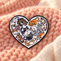 Heart Full of Cats enamel pin on a cozy peach knitted backdrop