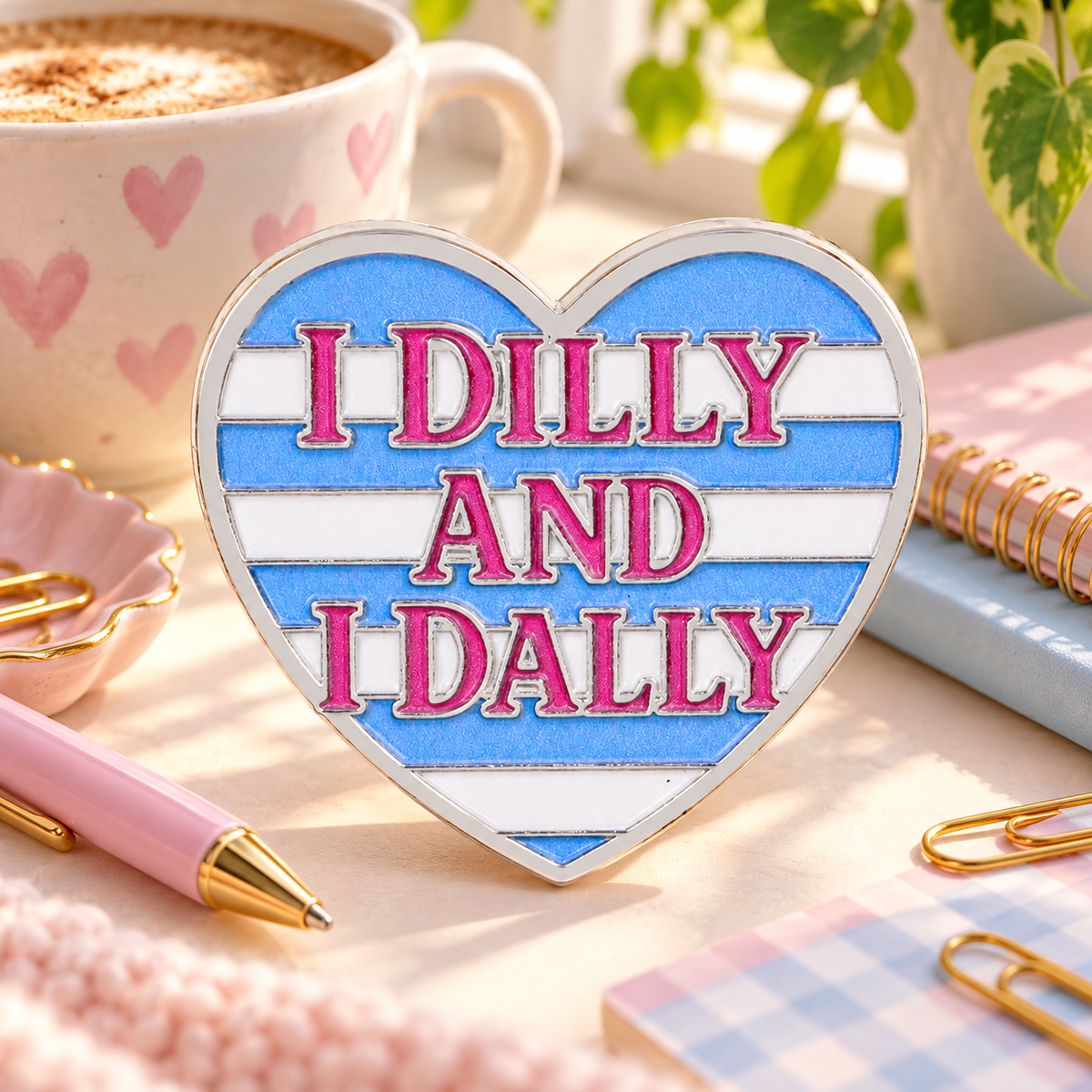 I Dilly and I Dally Heart Pin on a cozy pastel desk
