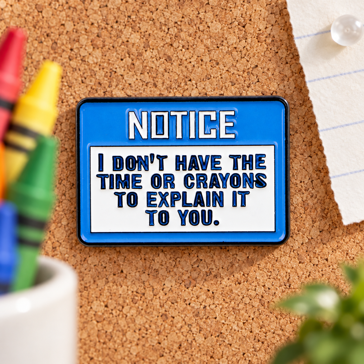 I Don't Have the Time or Crayons notice enamel pin on an office cork board