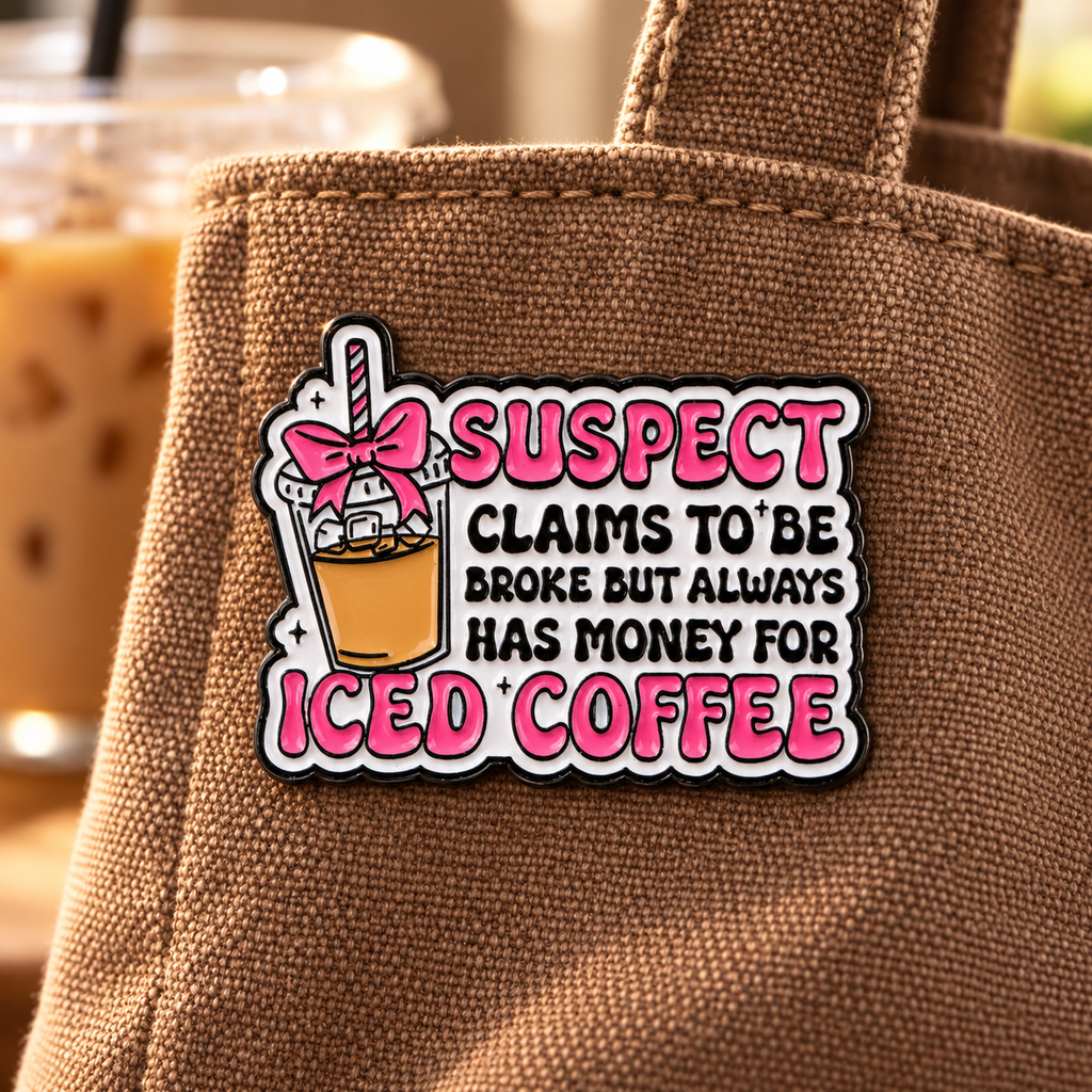 Iced coffee suspect enamel pin on mocha canvas