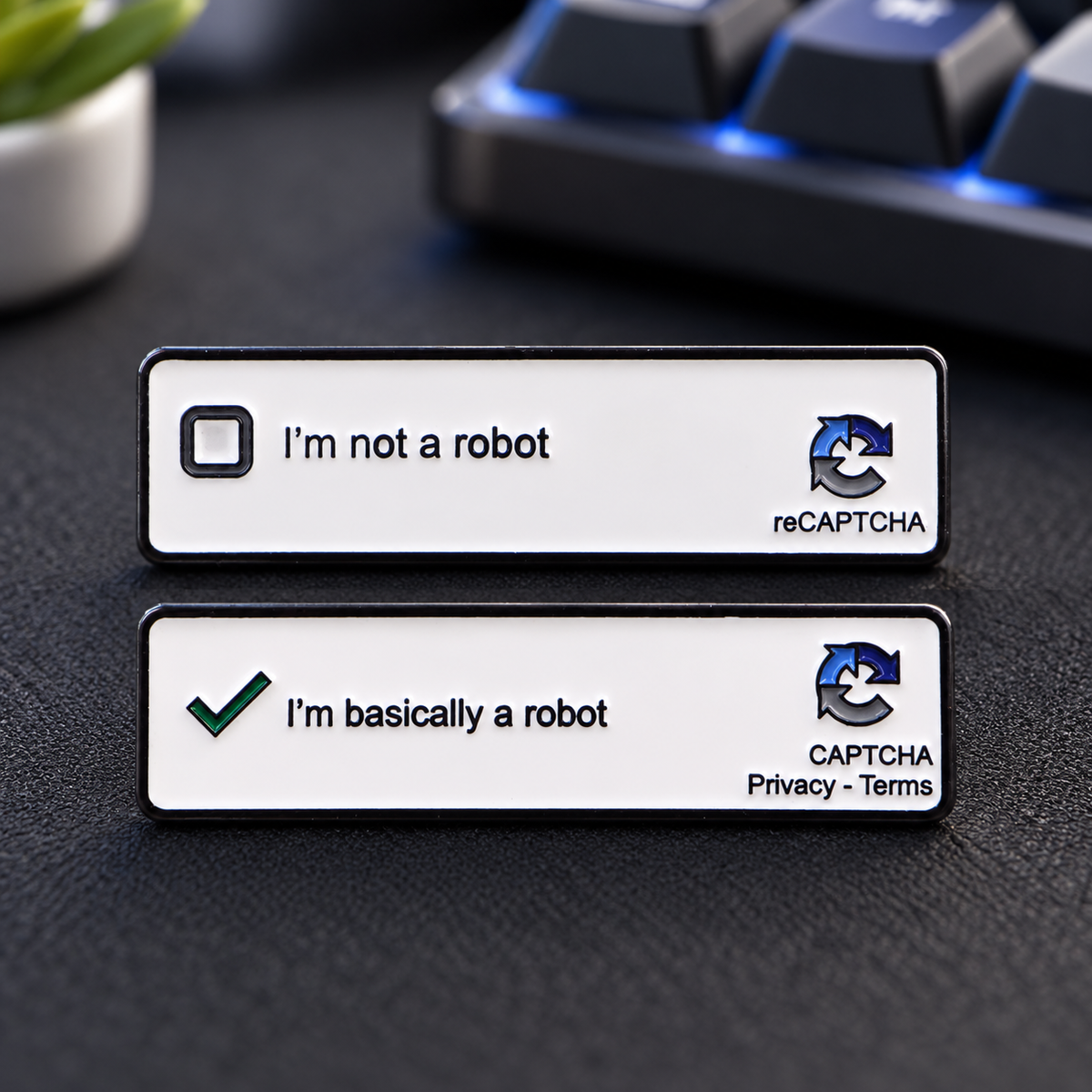 I'm Not a Robot reCAPTCHA enamel pin set on a charcoal desk mat