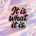 It Is What It Is pastel enamel pin on a soft lilac tabletop