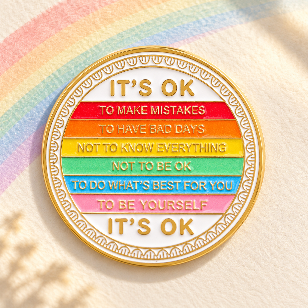 It's OK Rainbow Affirmations Pin on a pastel rainbow backdrop