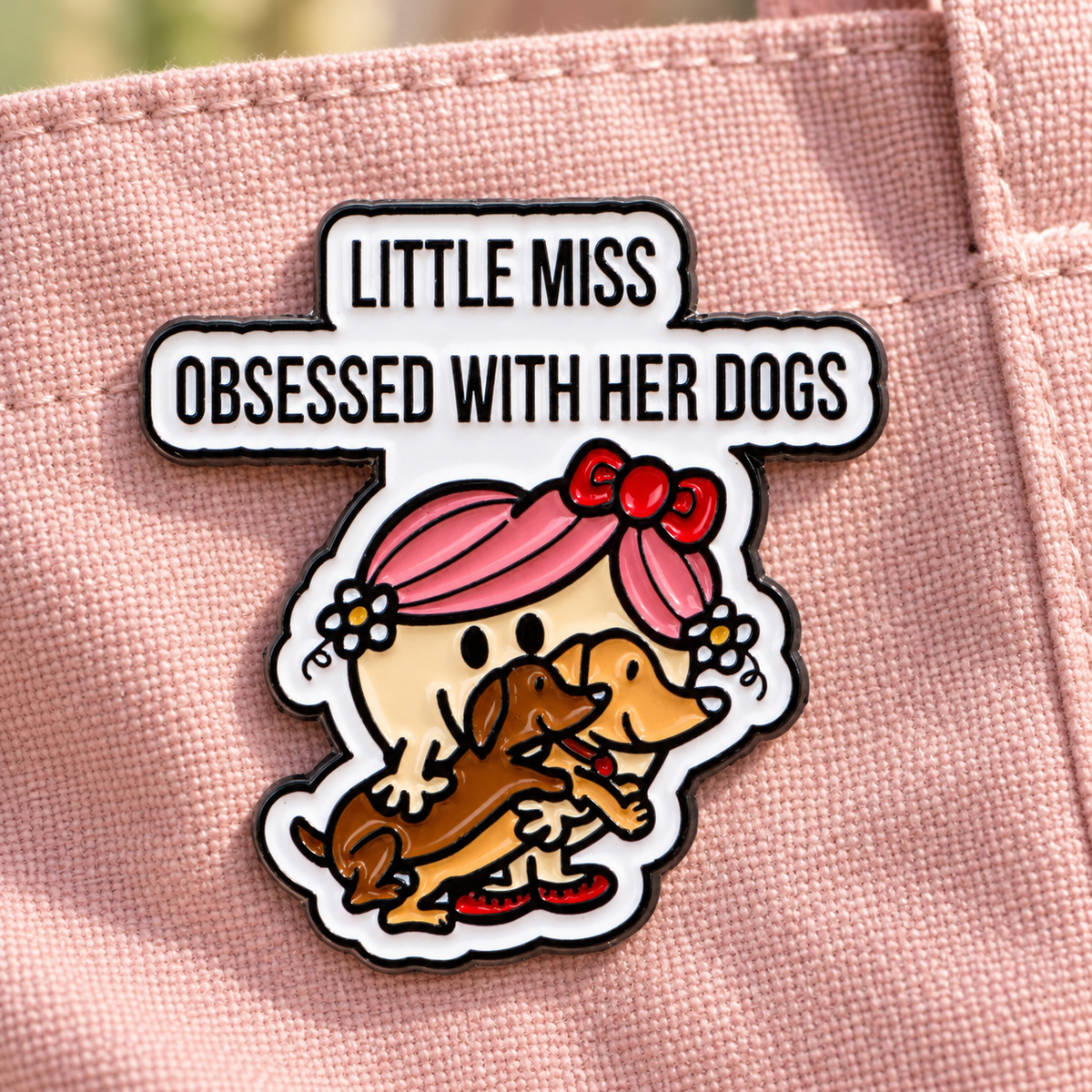 Little Miss Obsessed With Her Dogs enamel pin on blush canvas