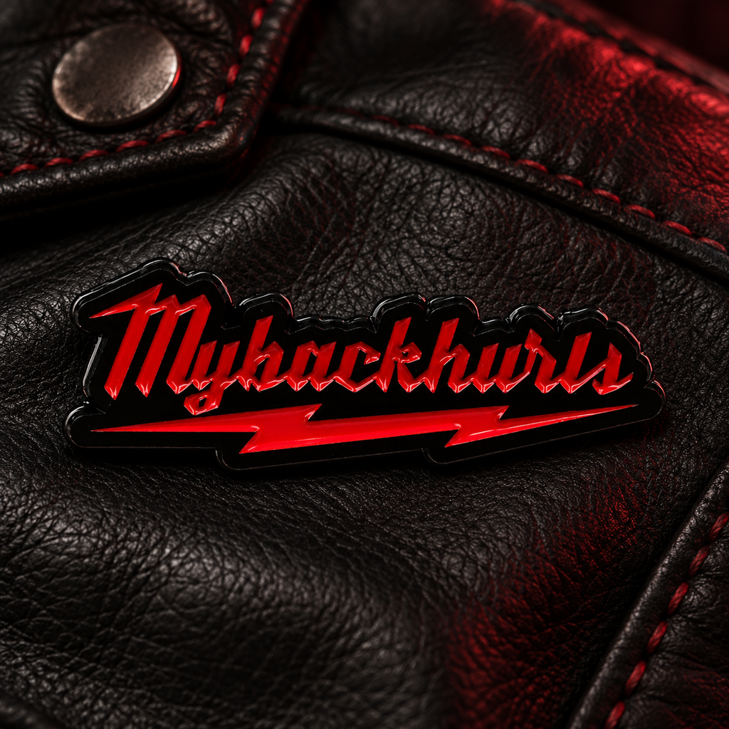My Back Hurts enamel pin on black leather with red stitching