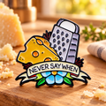 Never Say When Cheese Grater Pin on a warm cheese board